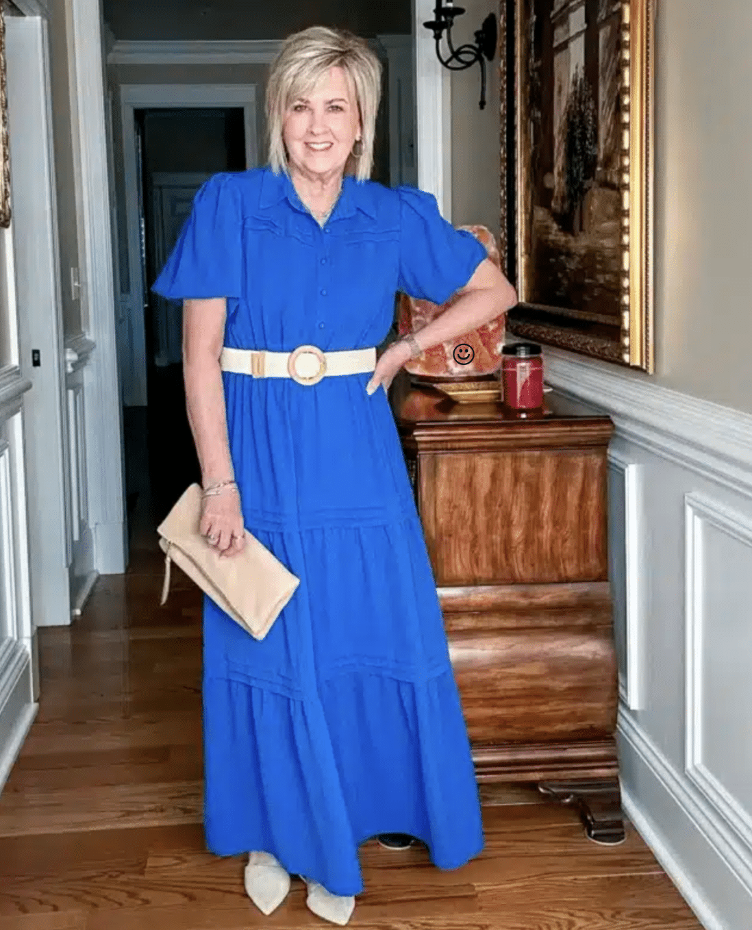 a woman in a blue dress with a raffia belt and clutch